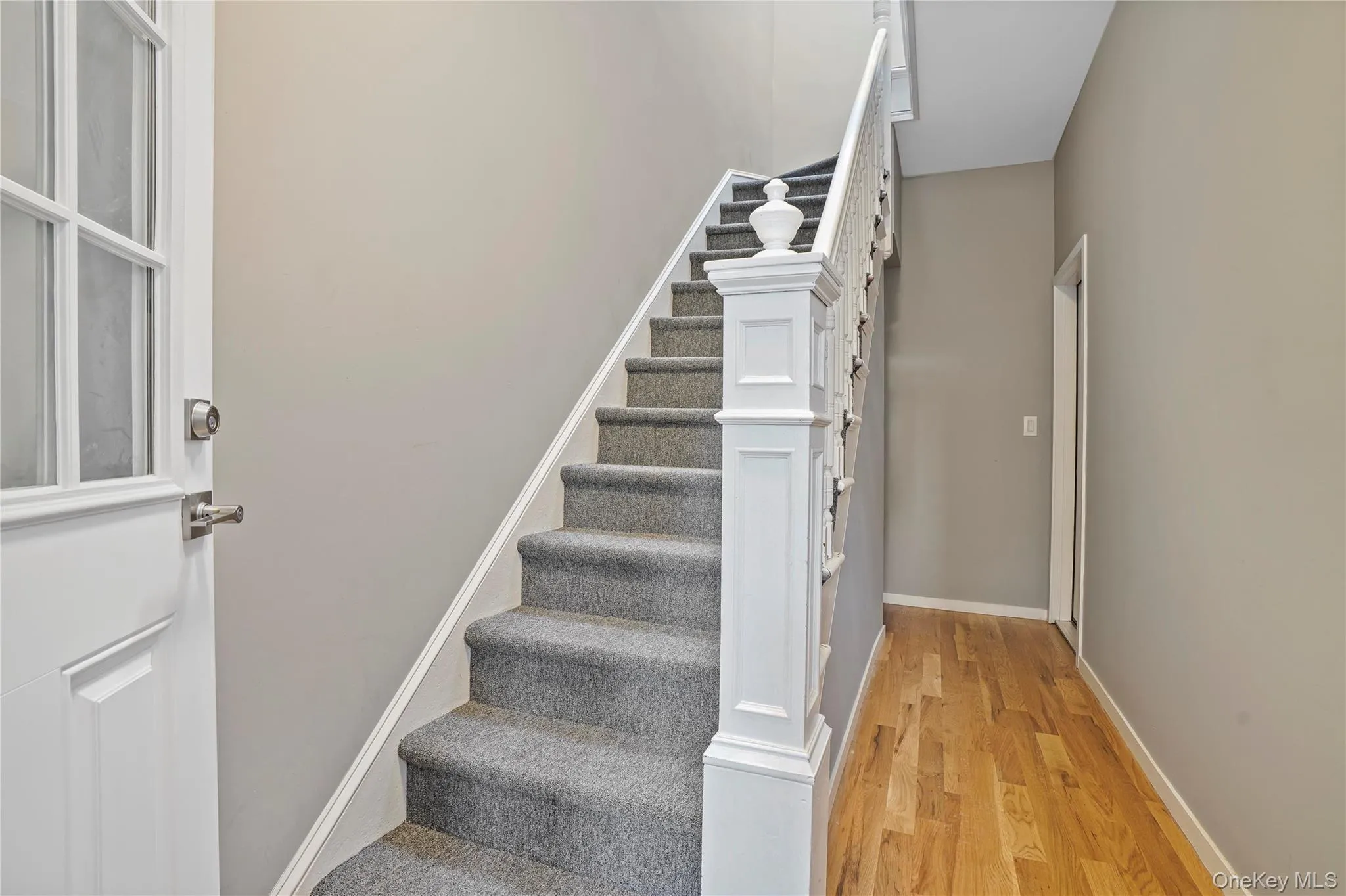 Stairs featuring wood finished floors and baseboards Stairs featuring wood finished floors and baseboards