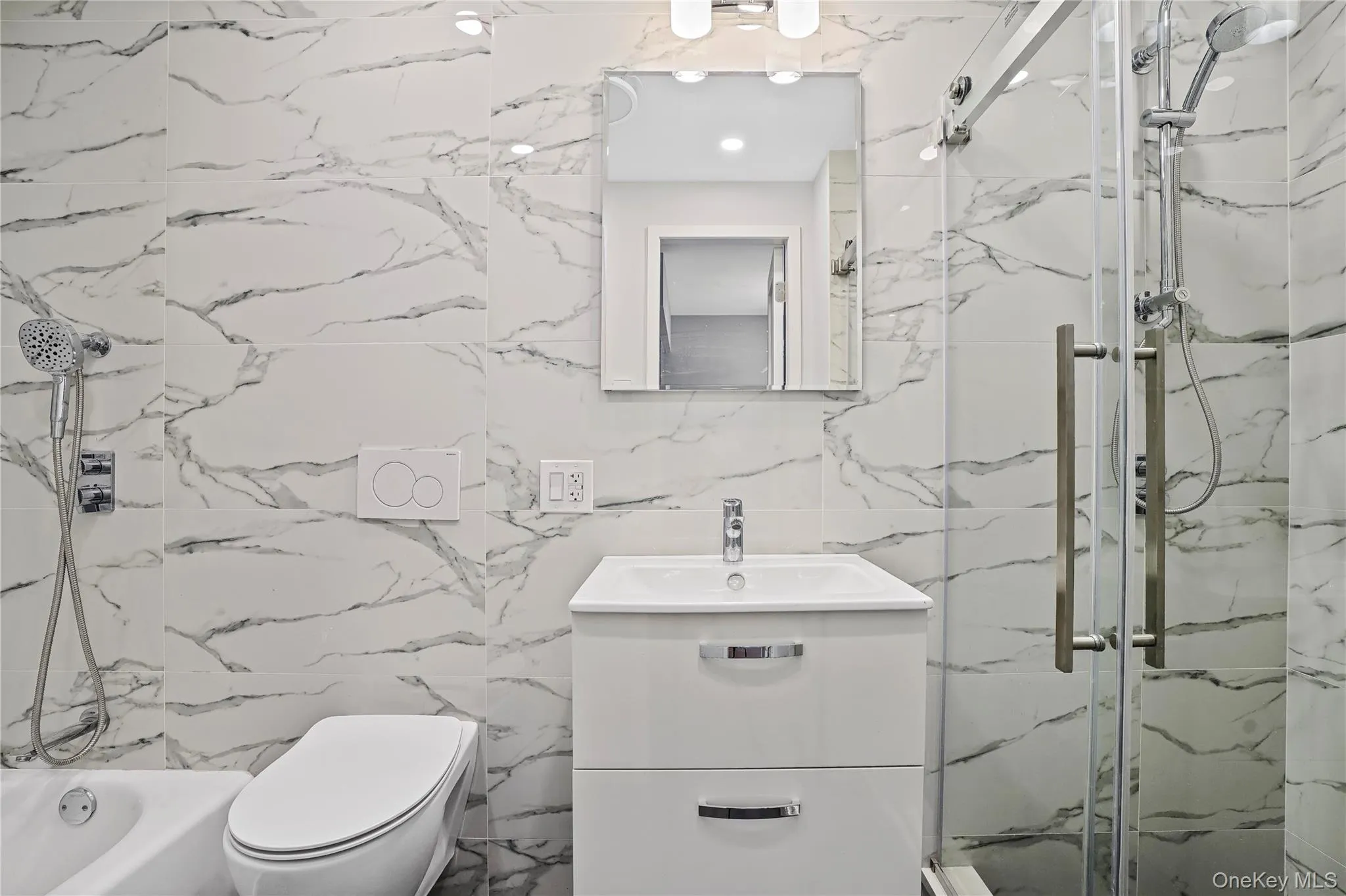 Full bath with a marble finish shower, vanity, tile walls, and a tub to relax in Full bath with a marble finish shower, vanity, tile walls, and a tub to relax in