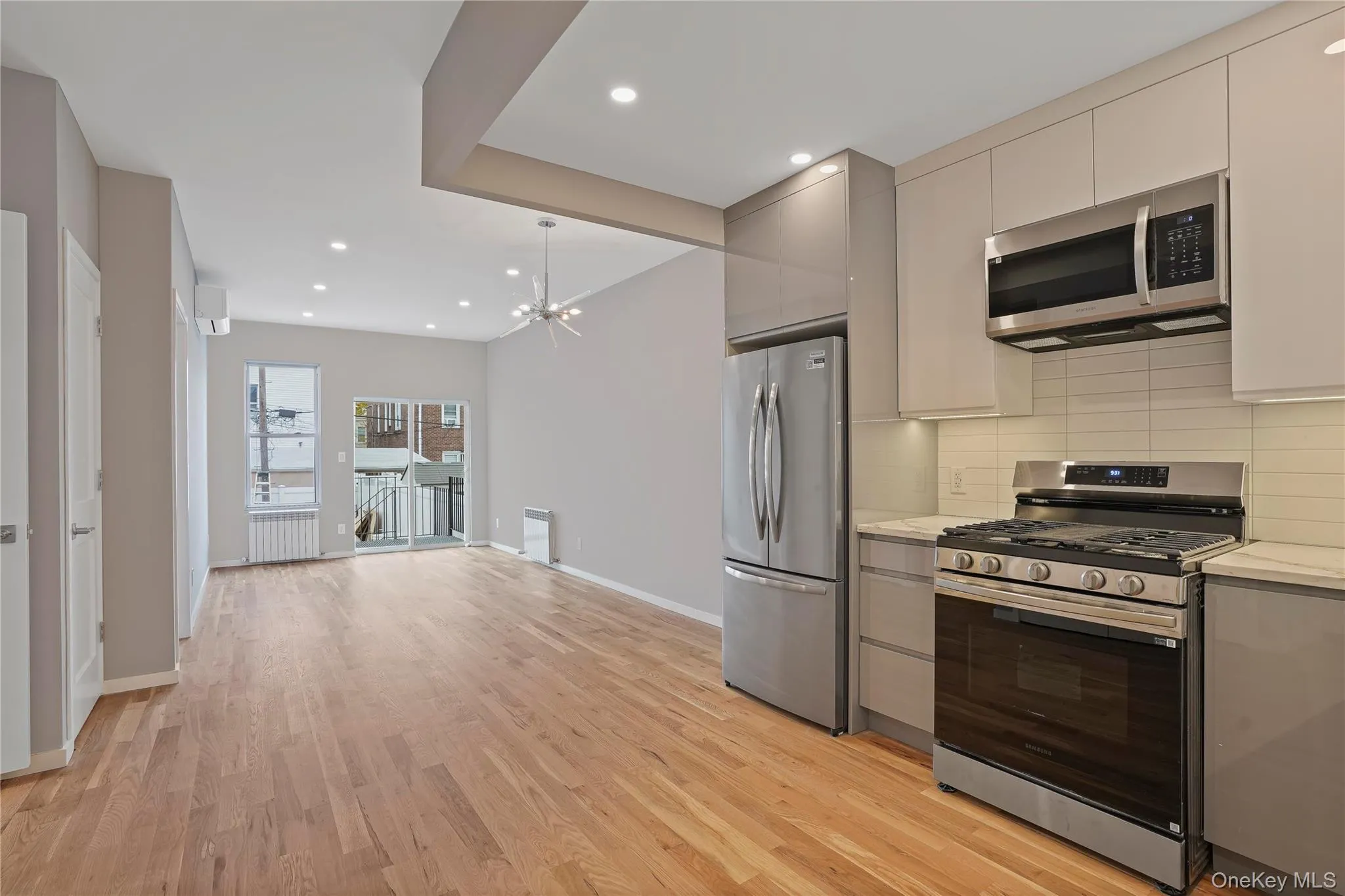 Kitchen featuring gray cabinetry, stainless steel appliances, tasteful backsplash, and recessed lighting Kitchen featuring gray cabinetry, stainless steel appliances, tasteful backsplash, and recessed lighting