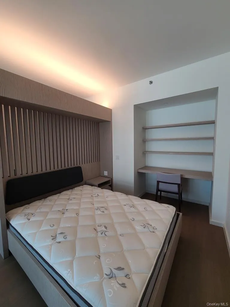 Bedroom featuring a closet and dark wood finished floors Bedroom featuring a closet and dark wood finished floors
