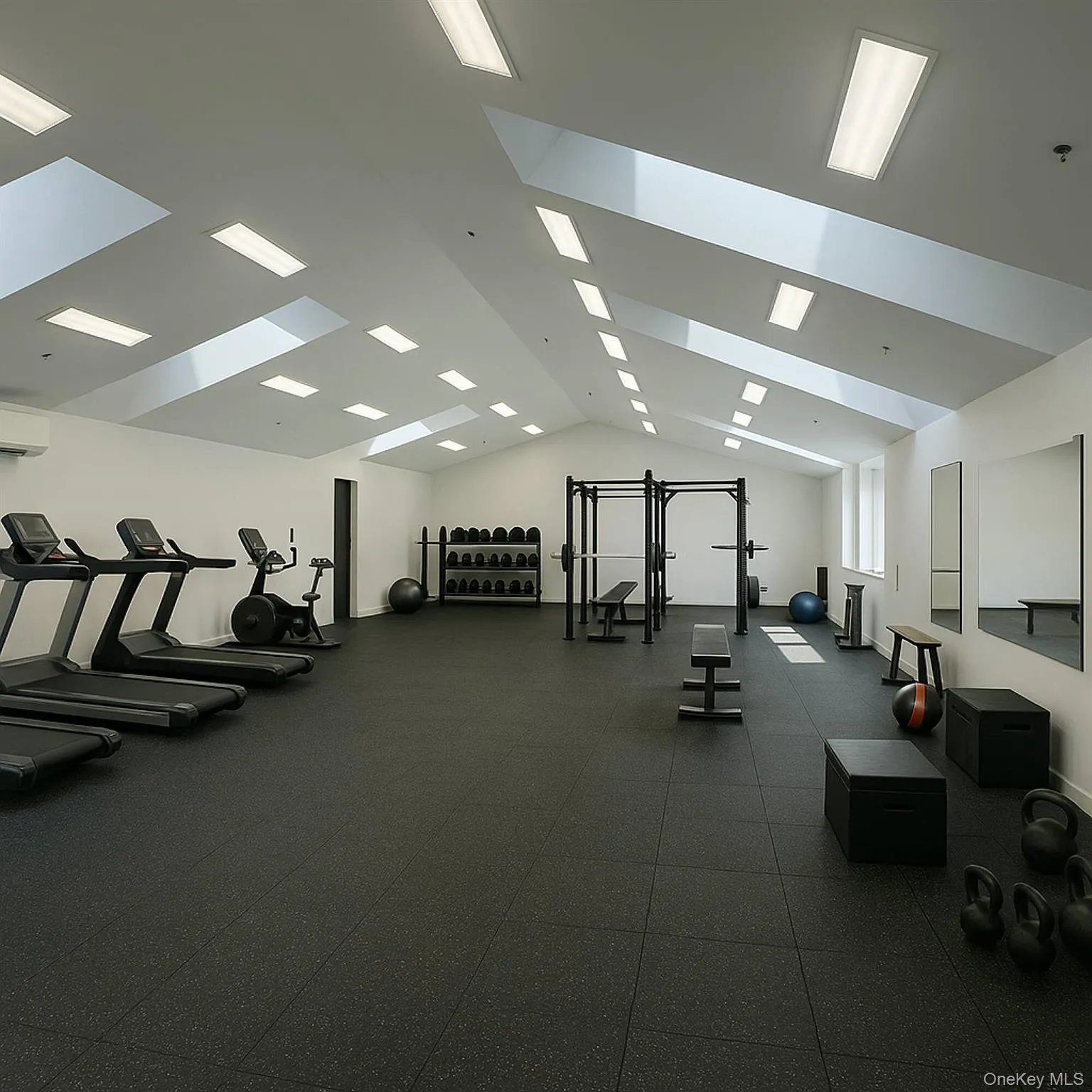 Gym with lofted ceiling and a wall mounted air conditioner Gym with lofted ceiling and a wall mounted air conditioner