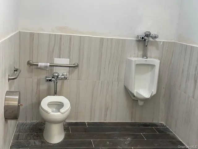 Bathroom with toilet and tile walls Bathroom with toilet and tile walls