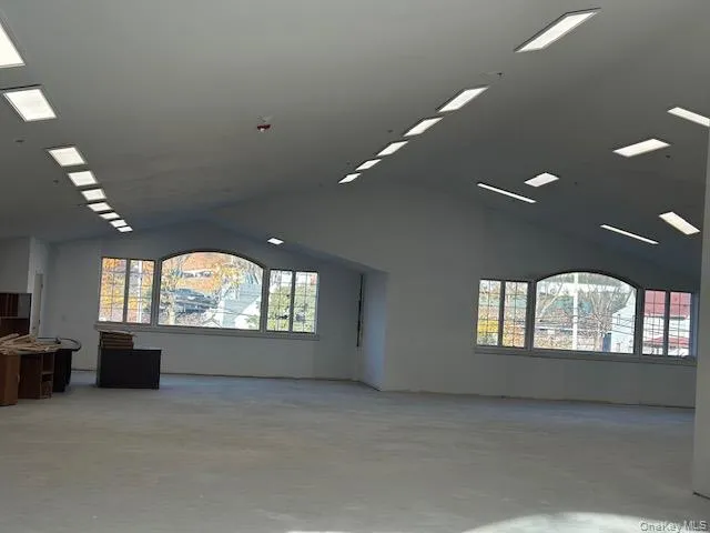 Spare room with lofted ceiling and concrete floors Spare room with lofted ceiling and concrete floors