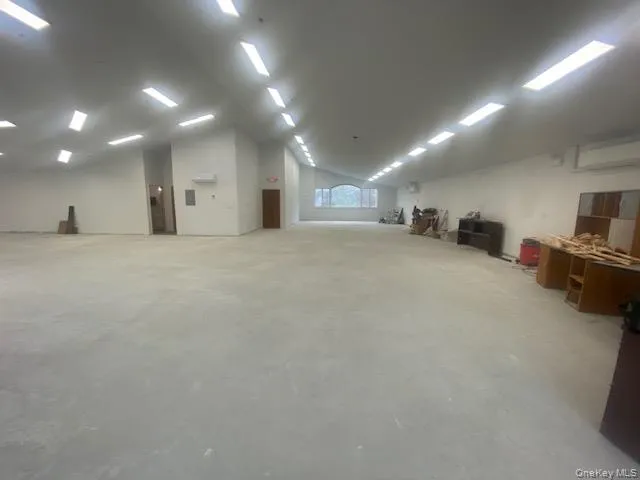 Miscellaneous room with lofted ceiling and a wall unit AC Miscellaneous room with lofted ceiling and a wall unit AC