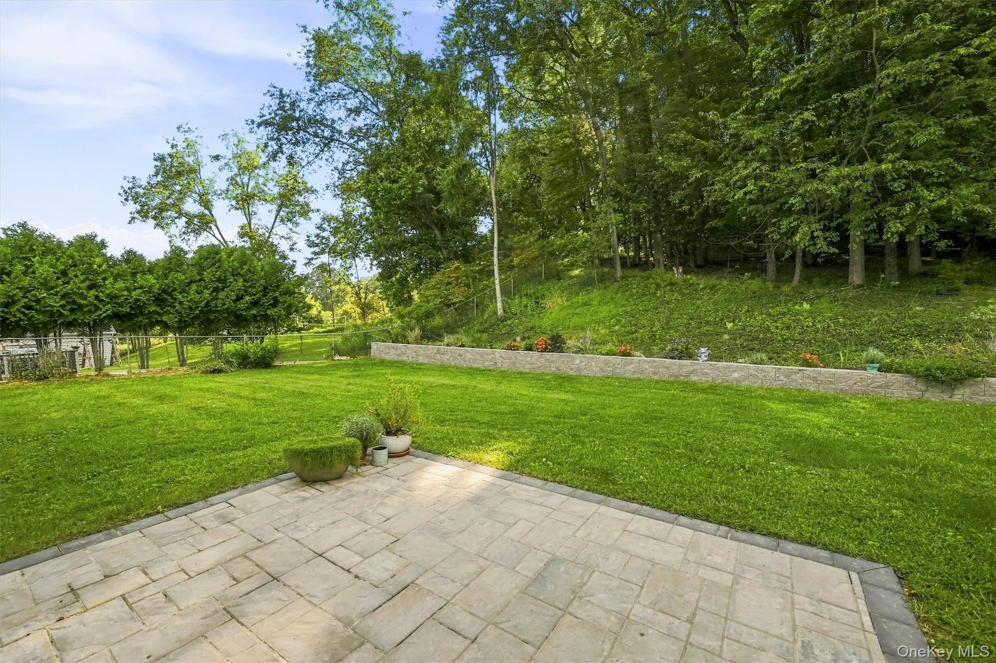 Brand new pavers create a large patio area for entertaining or relaxing, flanked by the new stone wall creating defniition and room for plant beds behind it... Brand new pavers create a large patio area for entertaining or relaxing, flanked by the new stone wall creating defniition and room for plant beds behind it...