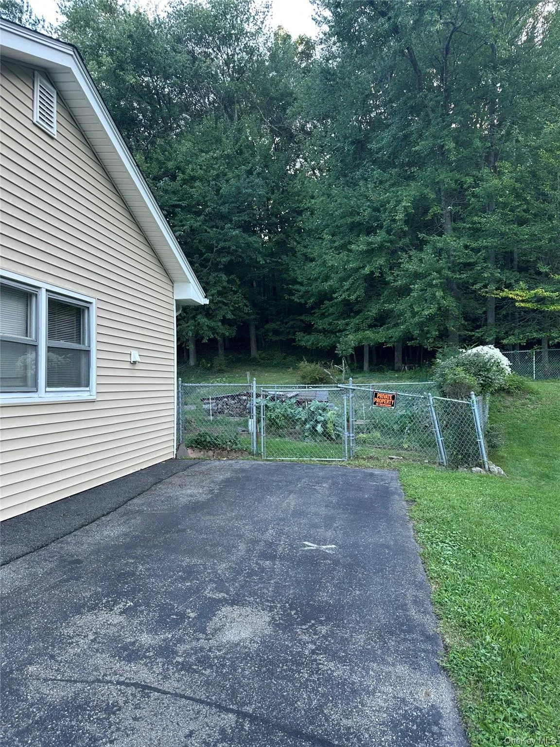 This extension of the paved driveway offers additional parking but perhaps in the future could be option to extend the home's footprint. The fenced garden area, of course, could be relocated to another part of the spacious back yard. This extension of the paved driveway offers additional parking but perhaps in the future could be option to extend the home's footprint. The fenced garden area, of course, could be relocated to another part of the spacious back yard.