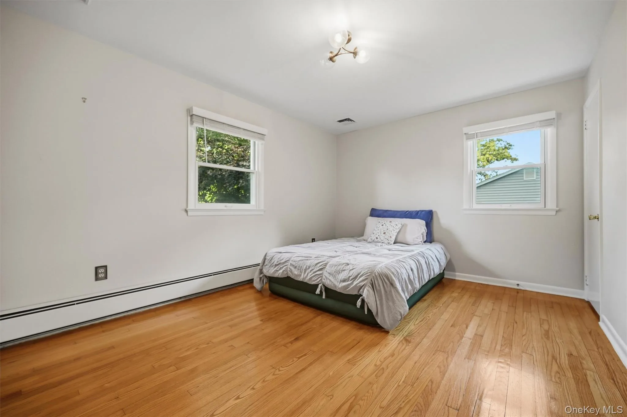 A king-size bed could easily fit in this spacious room with gleaming hardwood floors... A king-size bed could easily fit in this spacious room with gleaming hardwood floors...