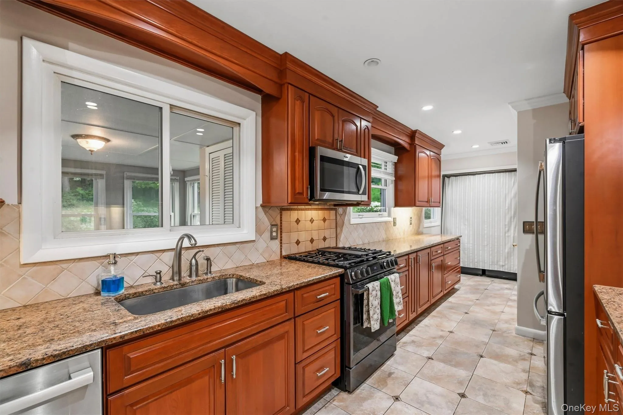 .Over the double sink, you'll look out to the back yard and into... .Over the double sink, you'll look out to the back yard and into...