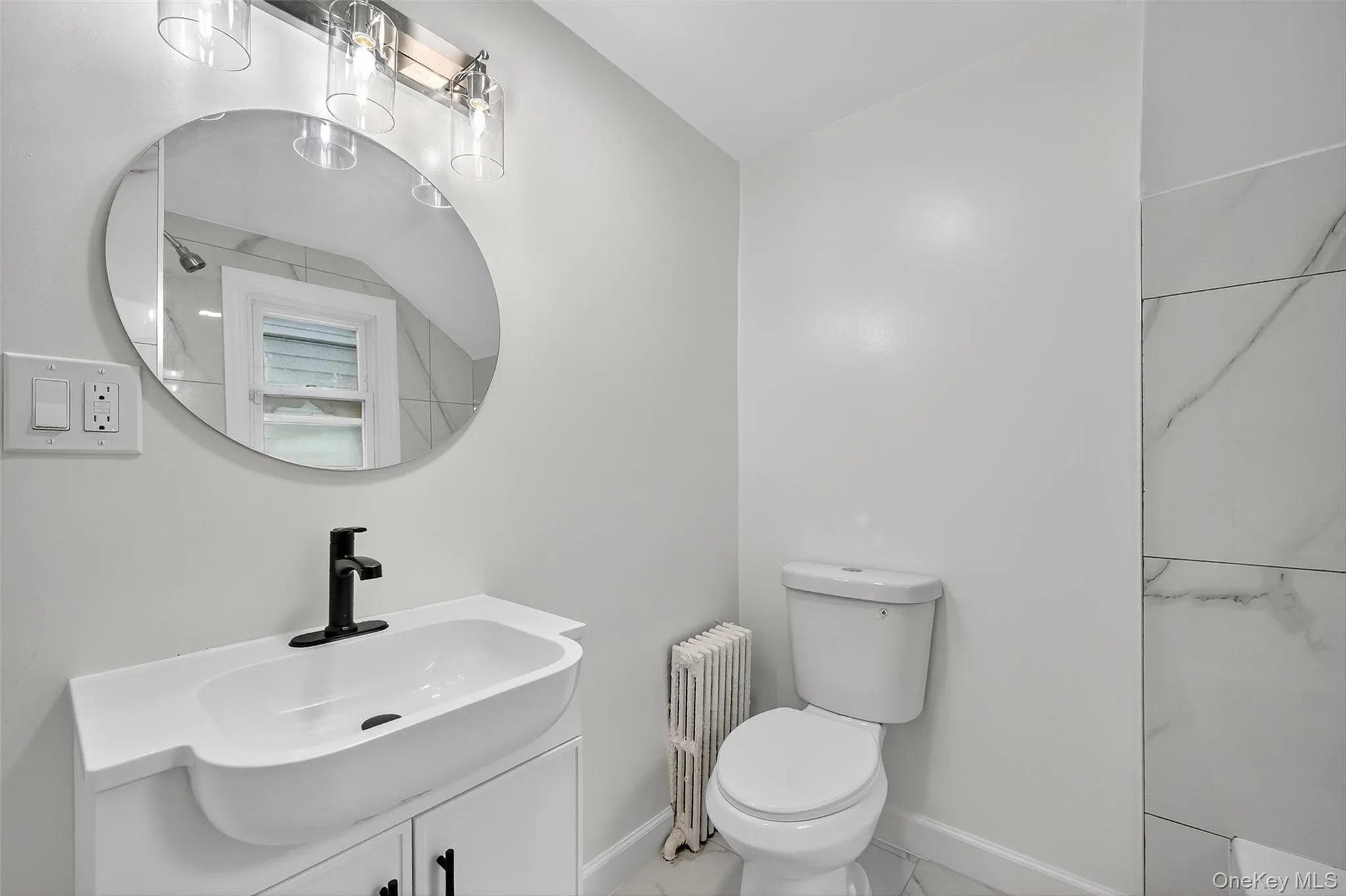 Full bathroom featuring radiator and vanity Full bathroom featuring radiator and vanity