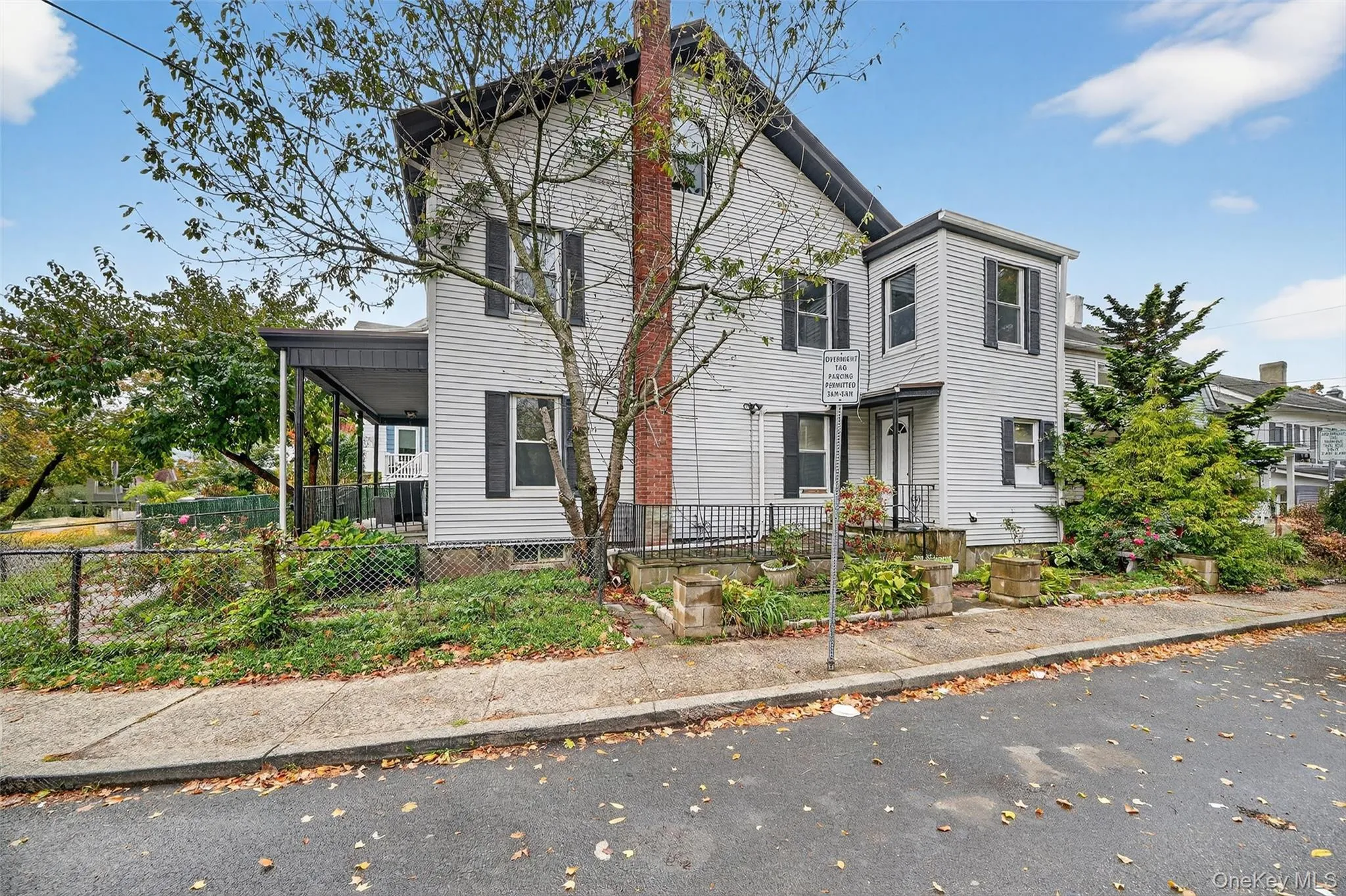 View of front of property with a porch and a fenced front yard View of front of property with a porch and a fenced front yard
