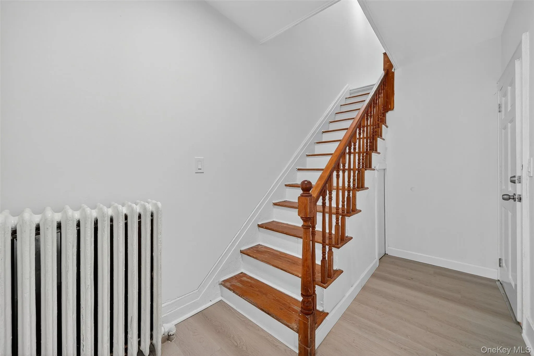 Stairs with radiator heating unit and wood finished floors Stairs with radiator heating unit and wood finished floors