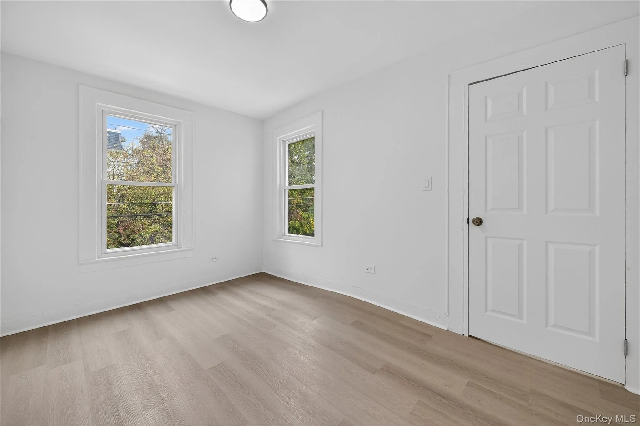 Unfurnished room featuring light wood-style floors and baseboards Unfurnished room featuring light wood-style floors and baseboards
