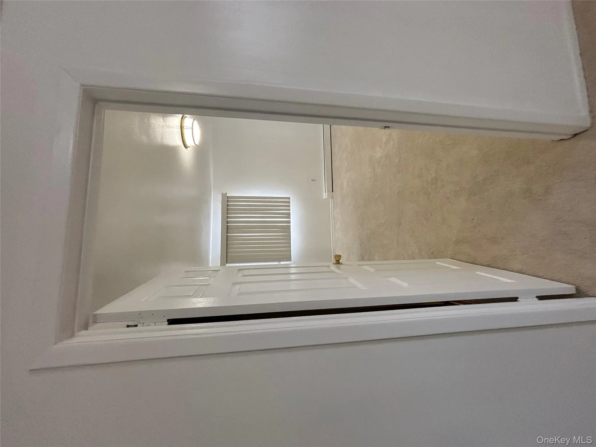 Corridor featuring light colored carpet and baseboard heating Corridor featuring light colored carpet and baseboard heating