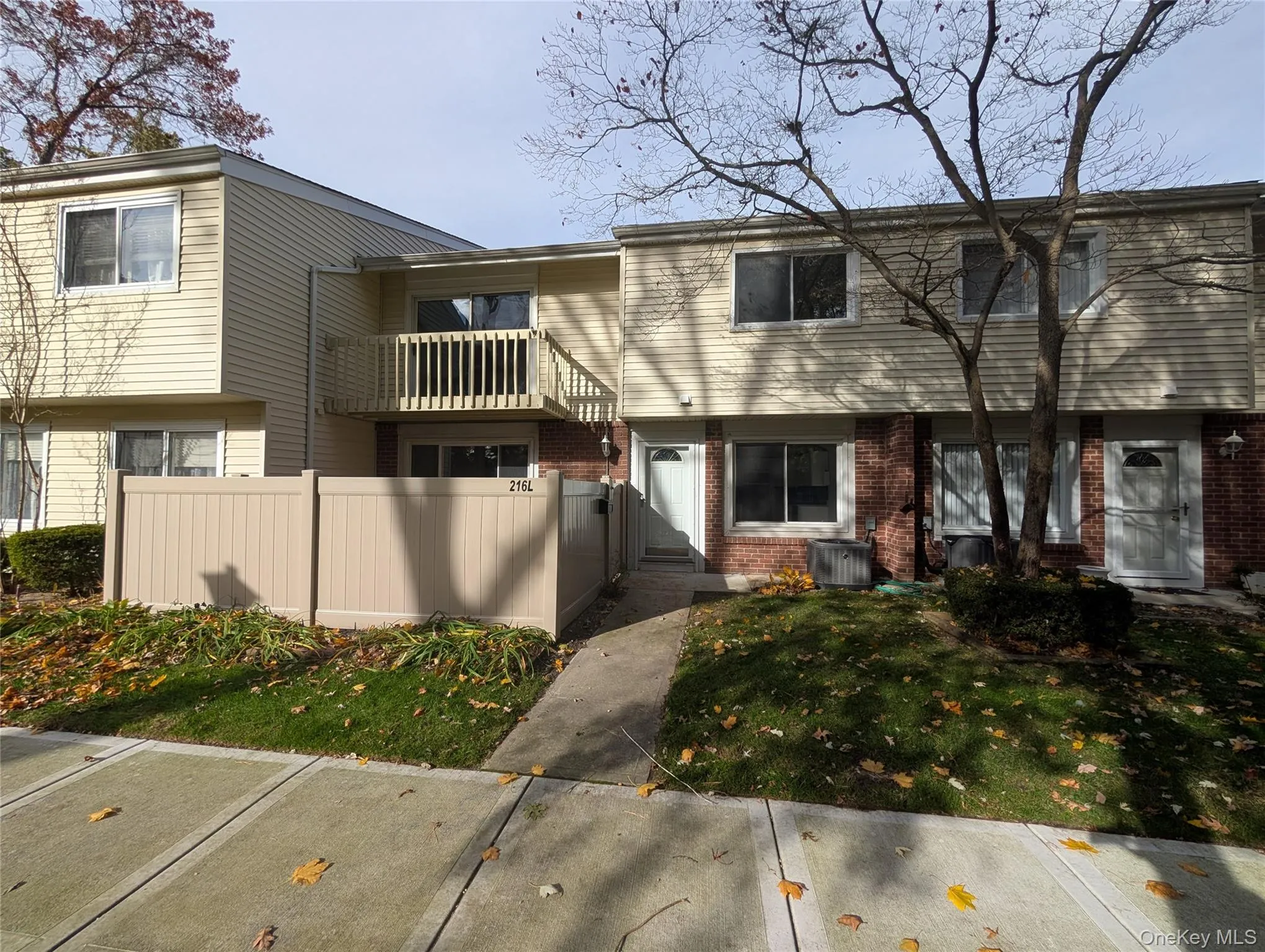 View of front of house with brick siding and a balcony View of front of house with brick siding and a balcony