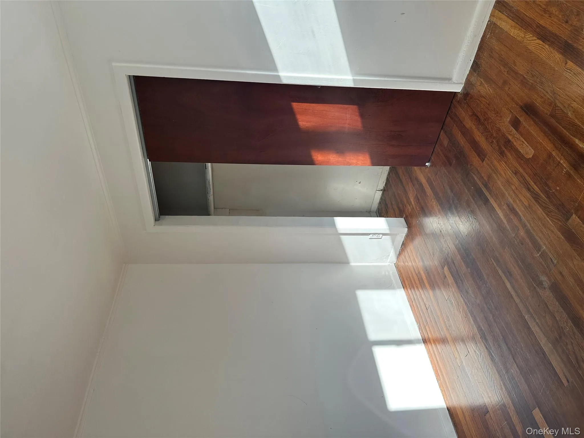 Unfurnished bedroom featuring dark wood finished floors, a closet, and ornamental molding Unfurnished bedroom featuring dark wood finished floors, a closet, and ornamental molding