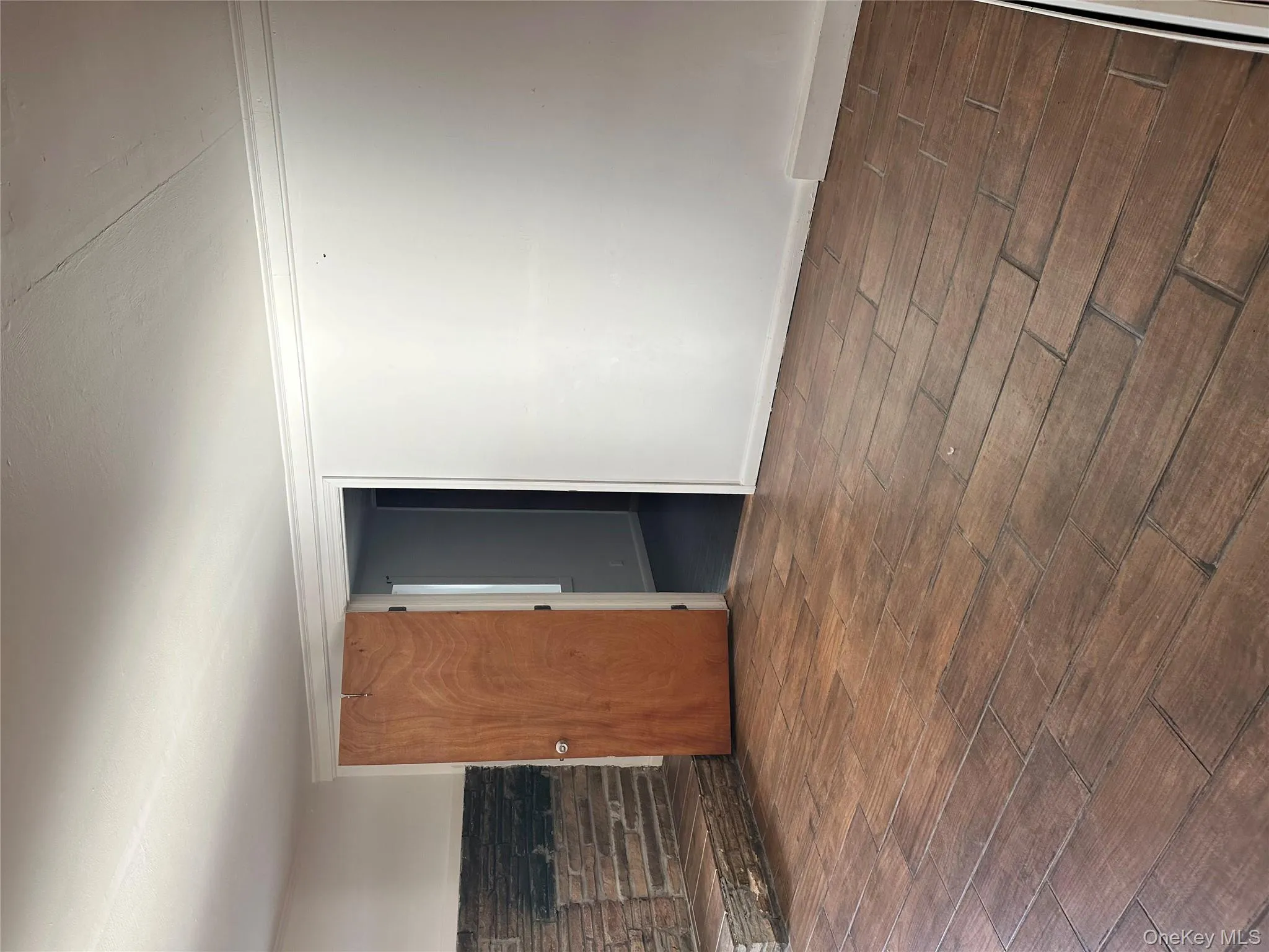 Spare room featuring dark wood-type flooring and crown molding Spare room featuring dark wood-type flooring and crown molding