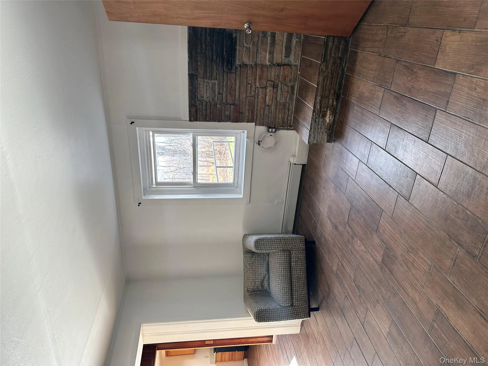 Sitting room featuring dark wood-style floors, wainscoting, crown molding, and a baseboard radiator Sitting room featuring dark wood-style floors, wainscoting, crown molding, and a baseboard radiator