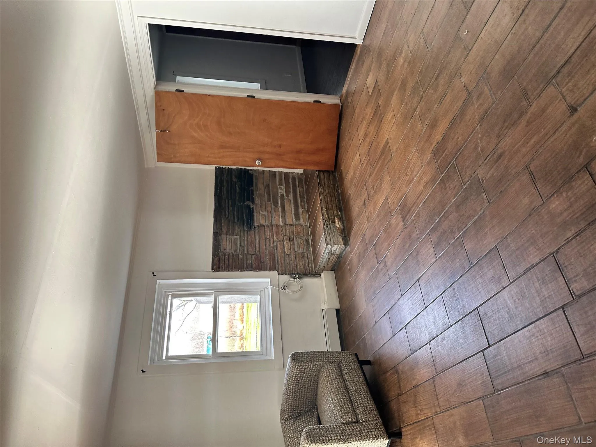 Living room featuring dark wood-style flooring and a baseboard radiator Living room featuring dark wood-style flooring and a baseboard radiator