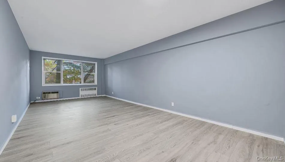 Large, open living area showing large windows, wall A/C, Radiator. Large, open living area showing large windows, wall A/C, Radiator.