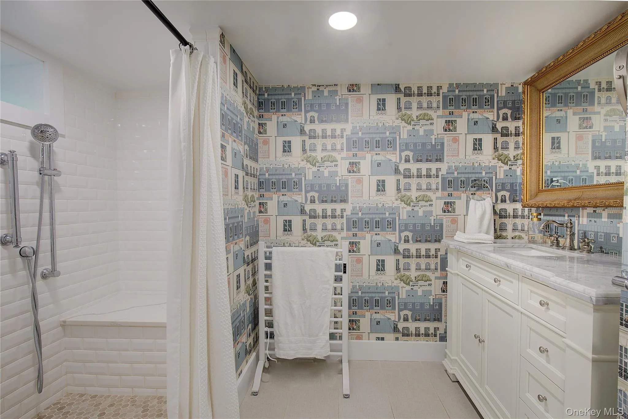 Bathroom featuring a shower stall, vanity, and light tile patterned floors Bathroom featuring a shower stall, vanity, and light tile patterned floors