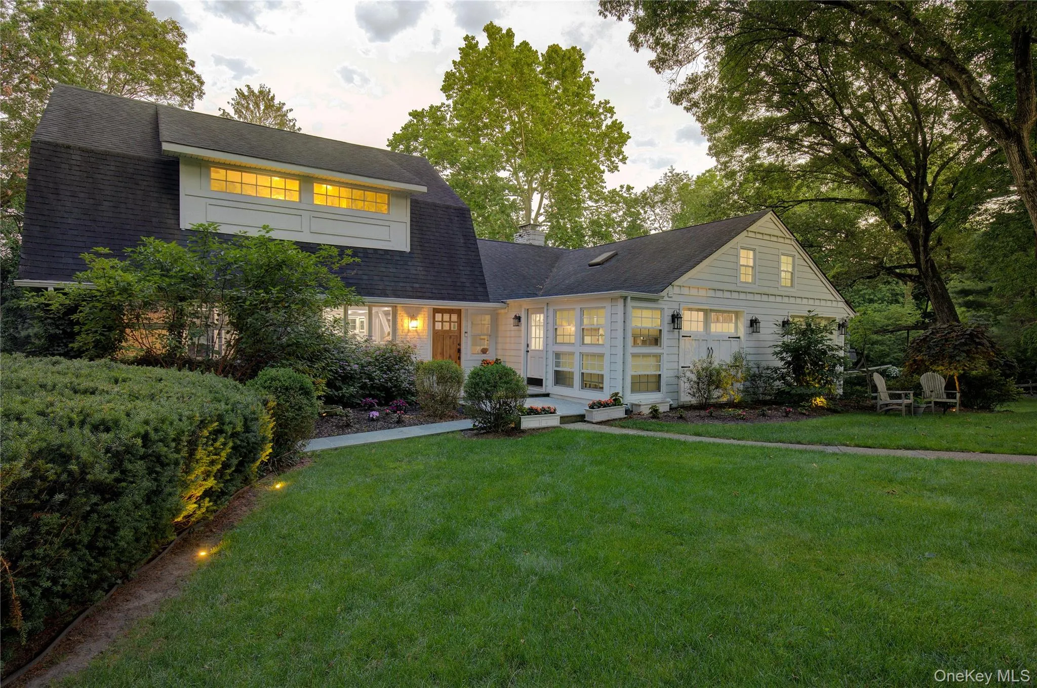 View of front of home featuring a yard, roof with shingles, and a gambrel roof View of front of home featuring a yard, roof with shingles, and a gambrel roof