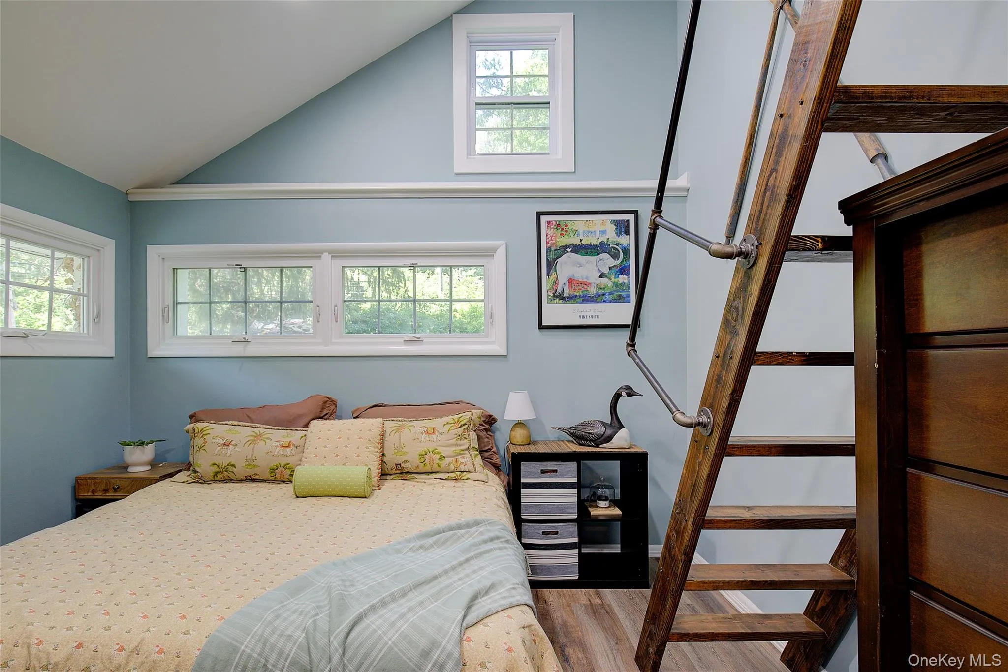 Bedroom with vaulted ceiling and light wood-style flooring Bedroom with vaulted ceiling and light wood-style flooring