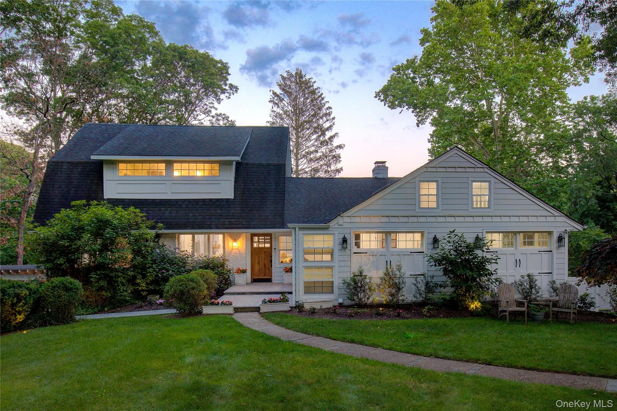 View of front facade featuring a front lawn, roof with shingles, and a chimney View of front facade featuring a front lawn, roof with shingles, and a chimney