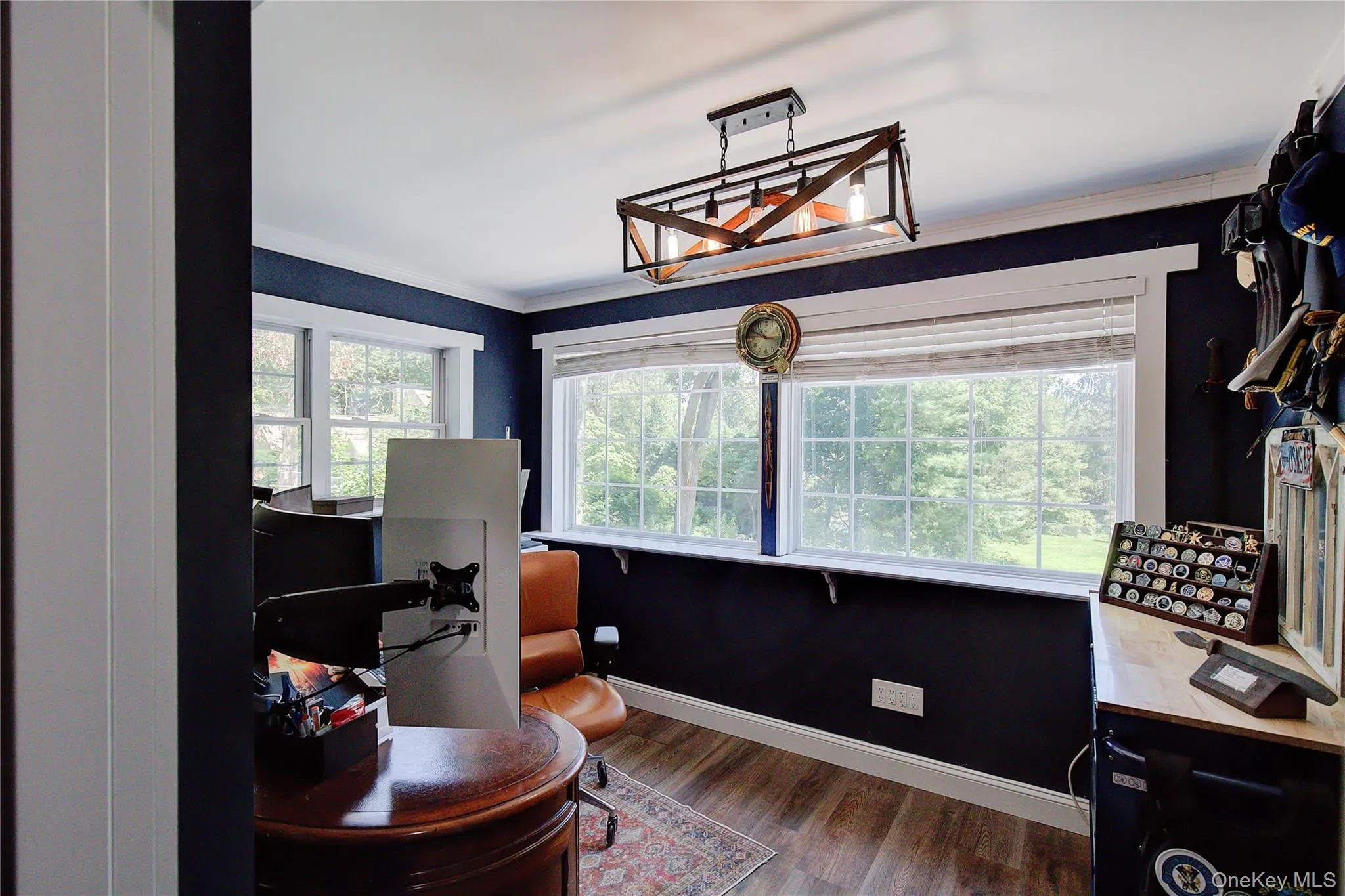 Office with ornamental molding, dark wood finished floors, and healthy amount of natural light Office with ornamental molding, dark wood finished floors, and healthy amount of natural light