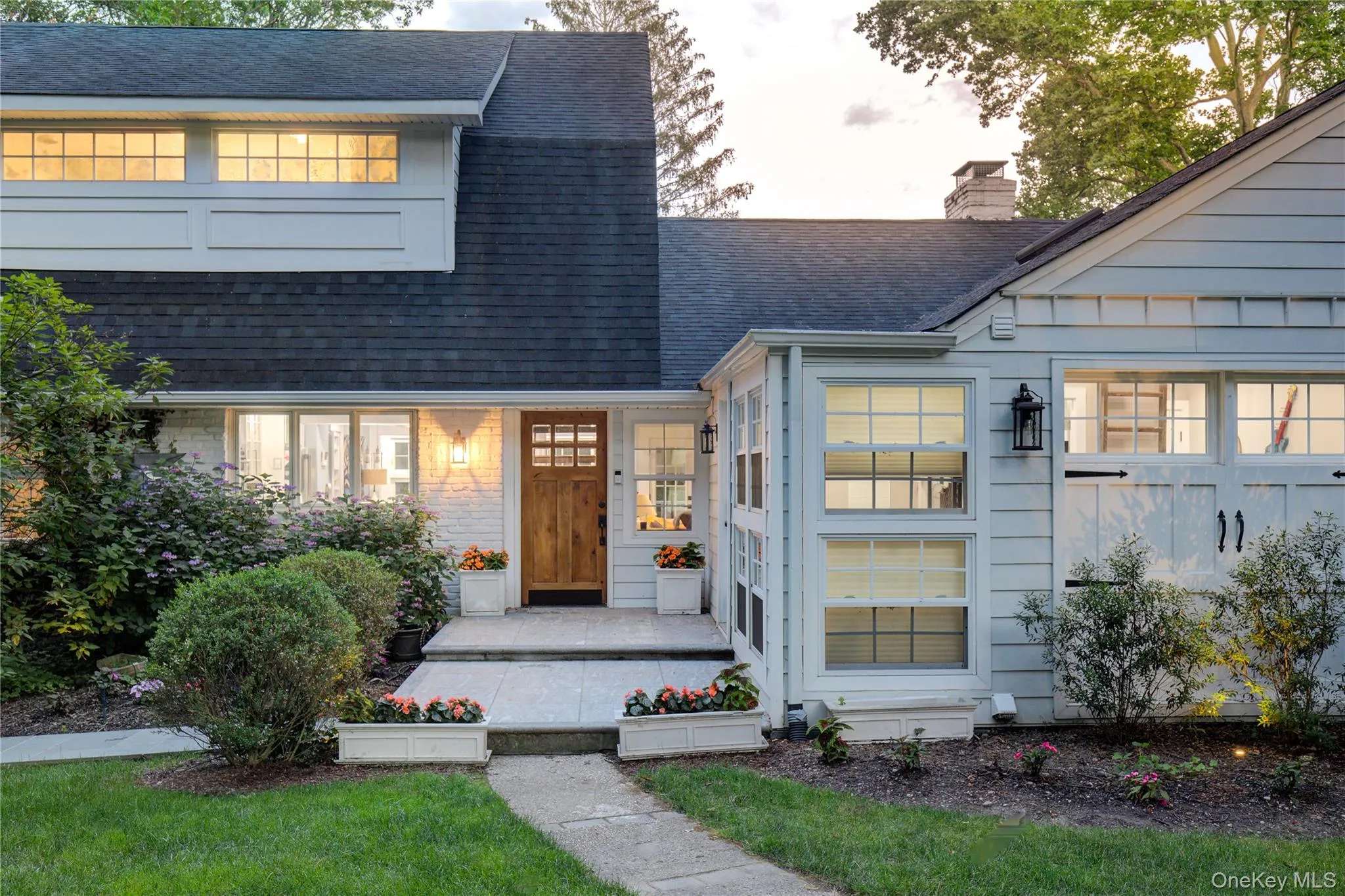 View of front of house featuring roof with shingles, a chimney, and a front lawn View of front of house featuring roof with shingles, a chimney, and a front lawn