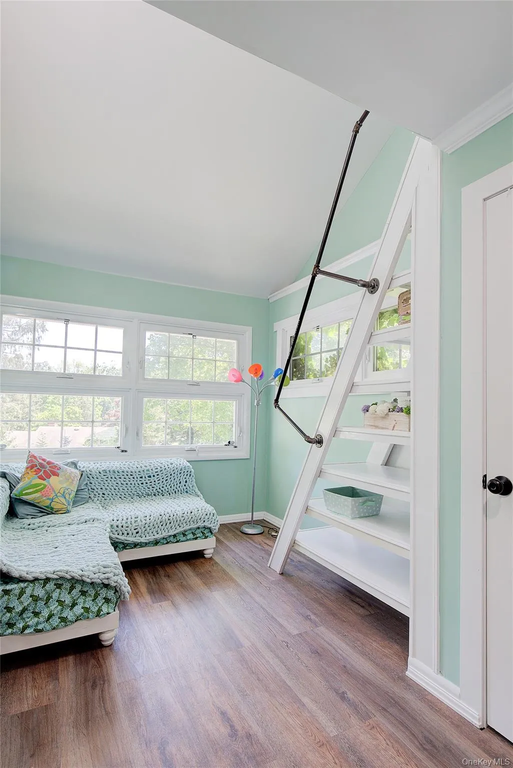 Bedroom featuring wood finished floors and crown molding Bedroom featuring wood finished floors and crown molding