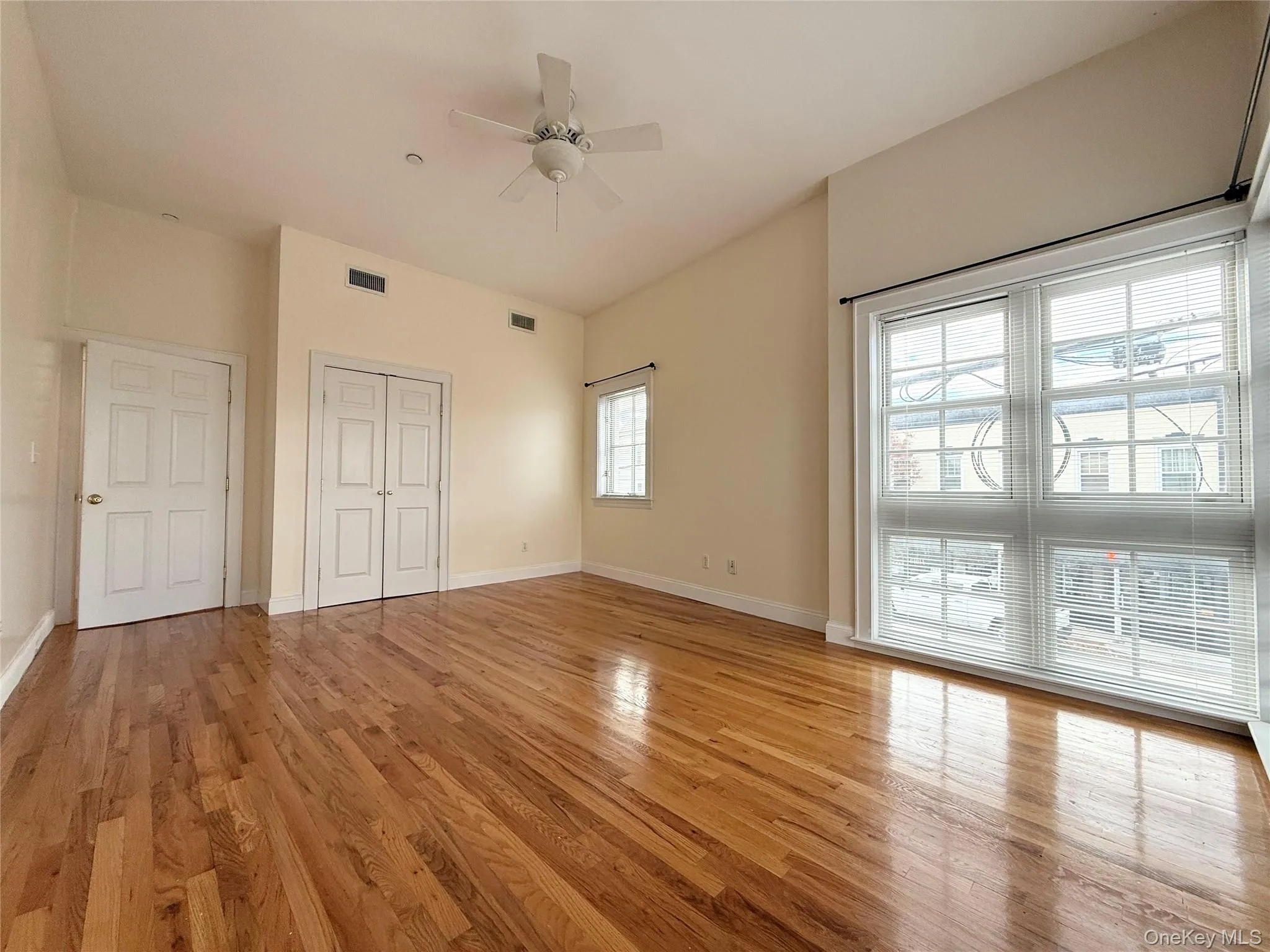 Unfurnished bedroom with light wood-type flooring, ceiling fan, and a closet Unfurnished bedroom with light wood-type flooring, ceiling fan, and a closet