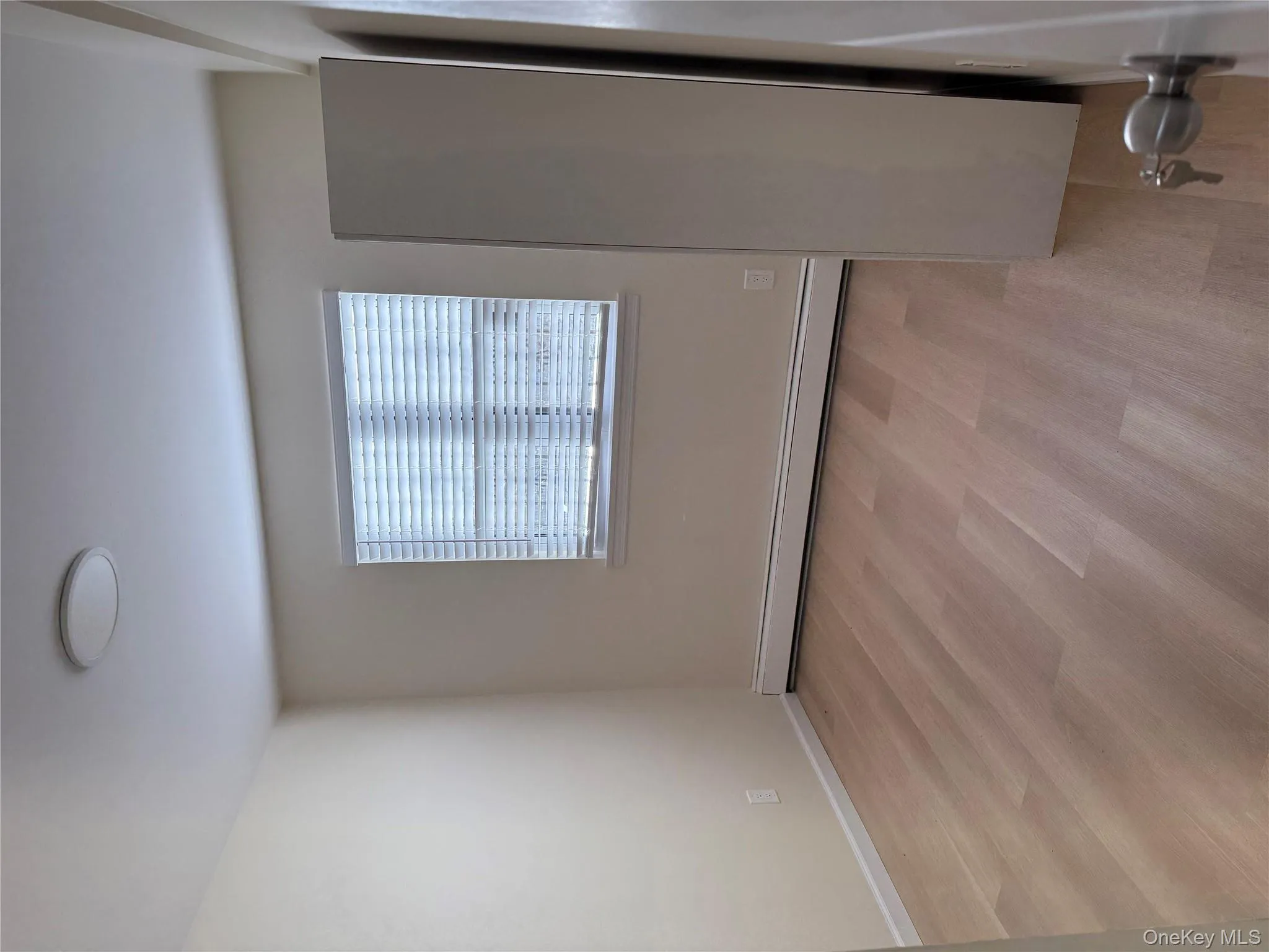 Spare room featuring a baseboard radiator and light wood-type flooring Spare room featuring a baseboard radiator and light wood-type flooring
