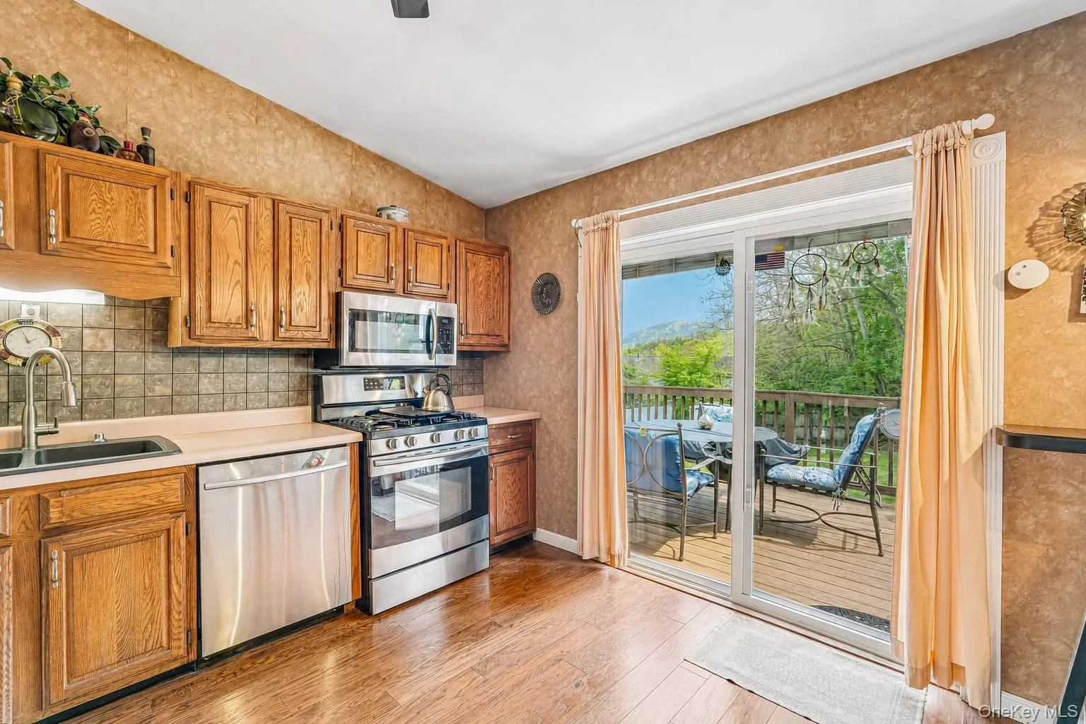 Kitchen featuring wood-finish flooring and a vaulted ceiling. Digitally enhanced photo Kitchen featuring wood-finish flooring and a vaulted ceiling. Digitally enhanced photo