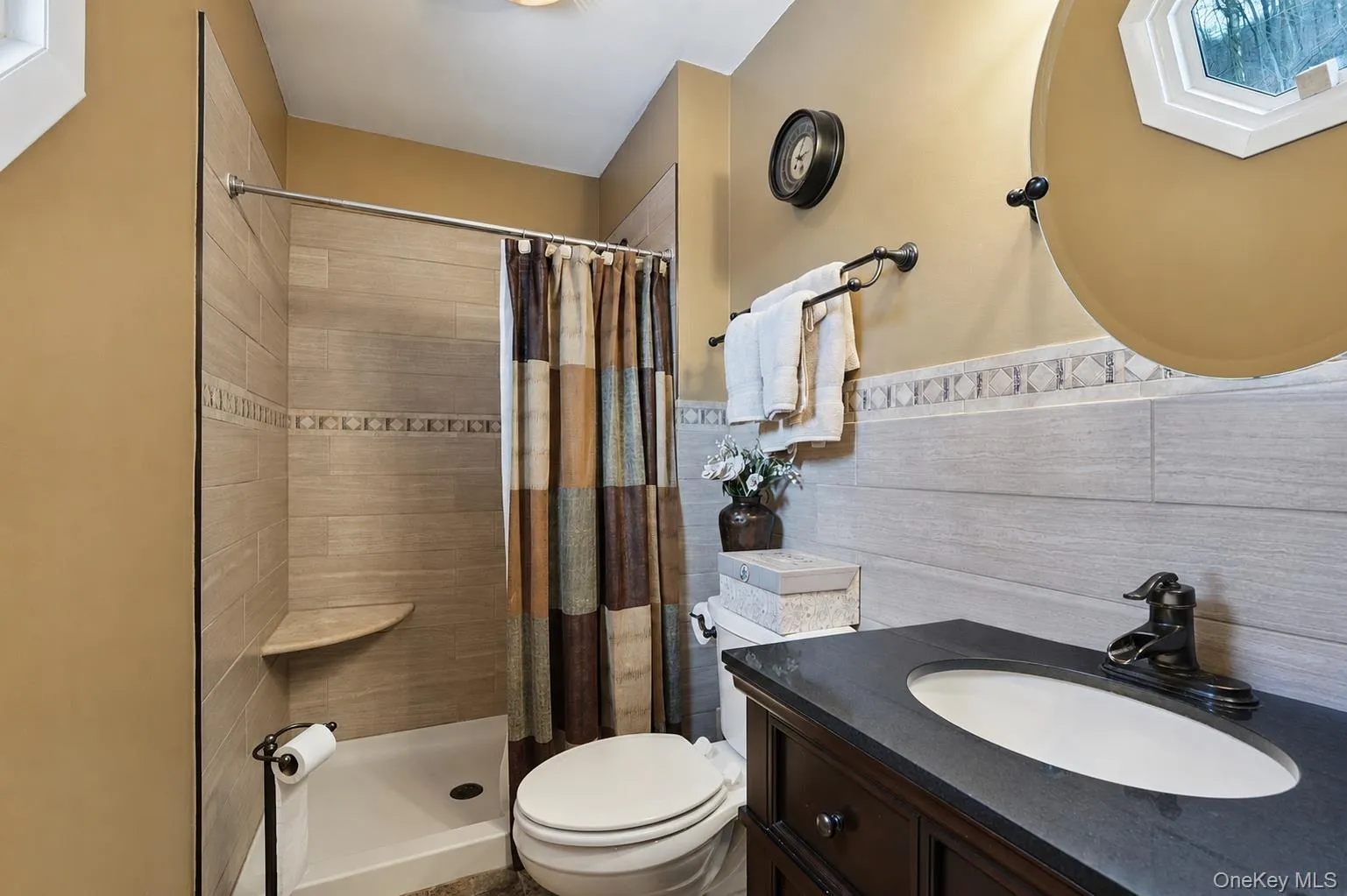 On-suite Full bathroom featuring vanity, a stall shower, tile walls. some photos may include virtually staged or digitally modified On-suite Full bathroom featuring vanity, a stall shower, tile walls. some photos may include virtually staged or digitally modified