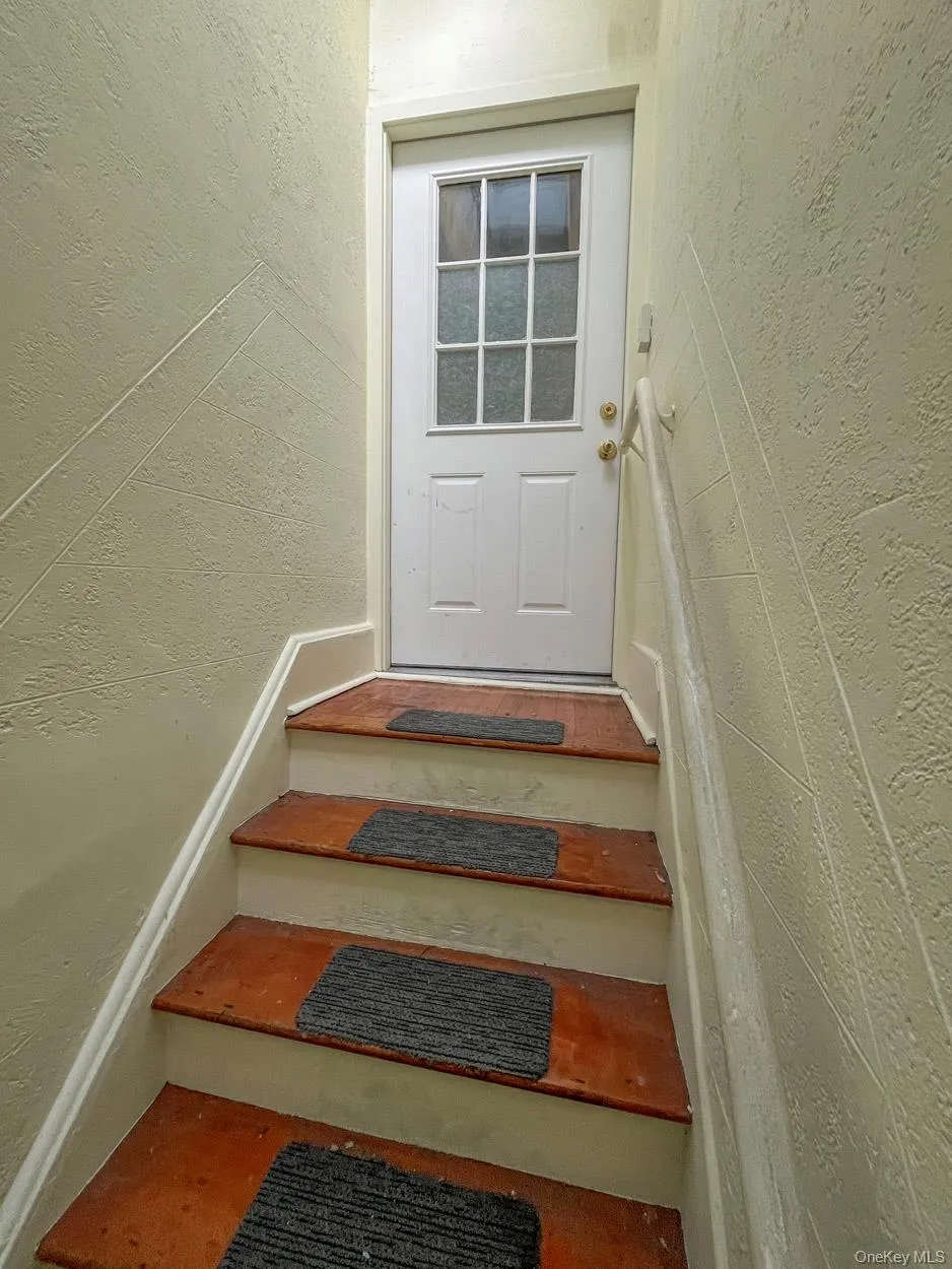 Stairs featuring a textured wall Stairs featuring a textured wall