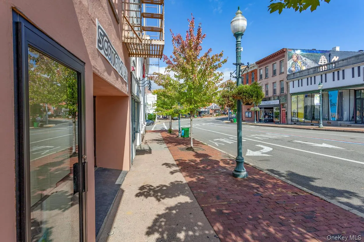 View of asphalt street featuring sidewalks, curbs, and street lighting View of asphalt street featuring sidewalks, curbs, and street lighting