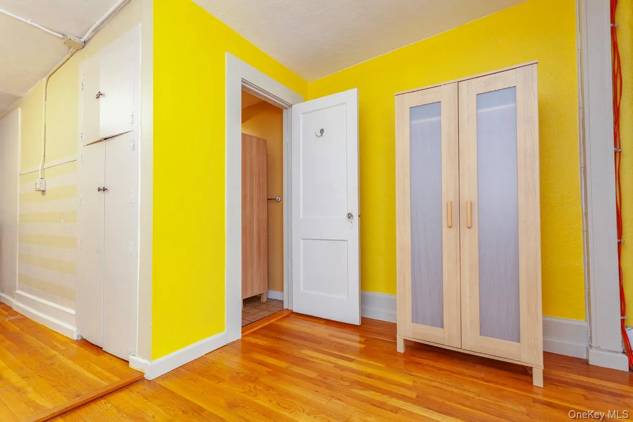Hallway with light wood-type flooring and french doors Hallway with light wood-type flooring and french doors
