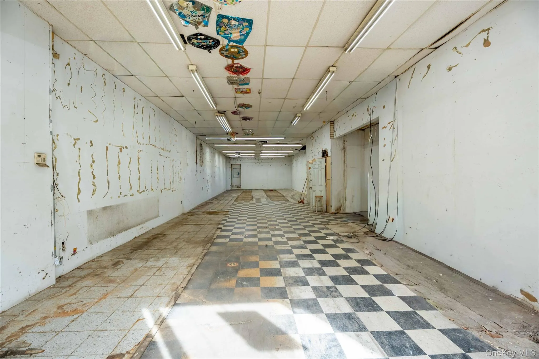 Basement with a paneled ceiling and tile patterned floors Basement with a paneled ceiling and tile patterned floors