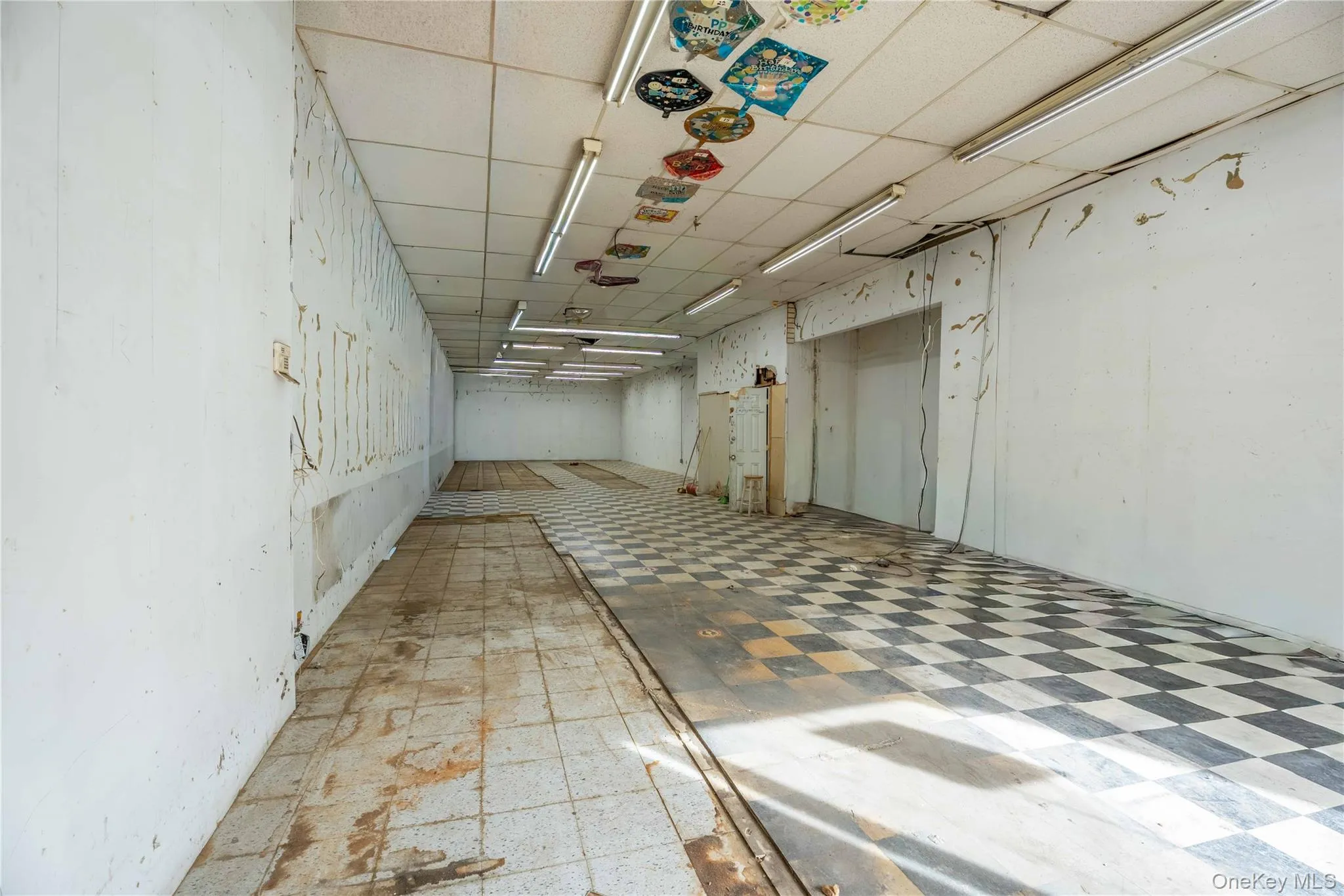 Basement featuring a paneled ceiling and tile patterned floors Basement featuring a paneled ceiling and tile patterned floors