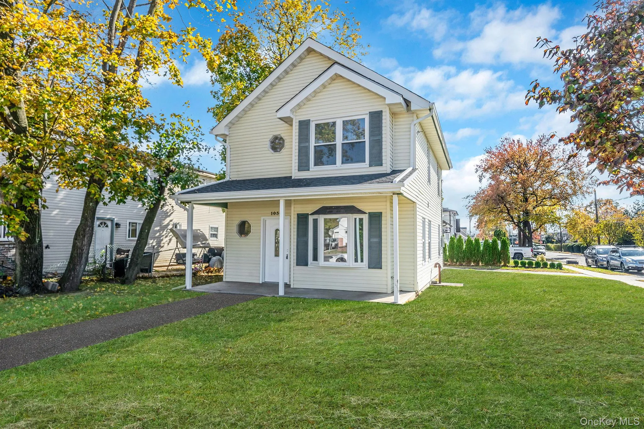 Traditional home featuring a front lawn and a porch Traditional home featuring a front lawn and a porch