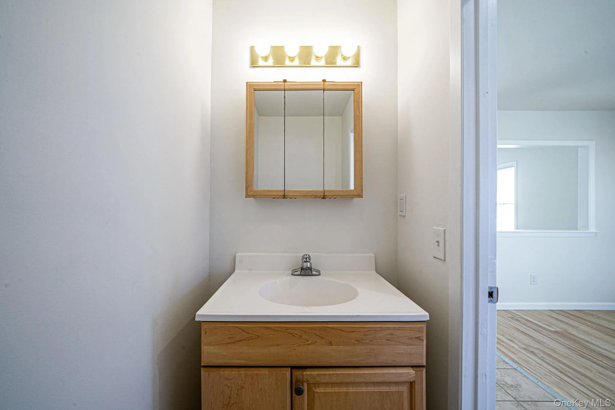 Half bathroom featuring vanity and tile patterned floors Half bathroom featuring vanity and tile patterned floors