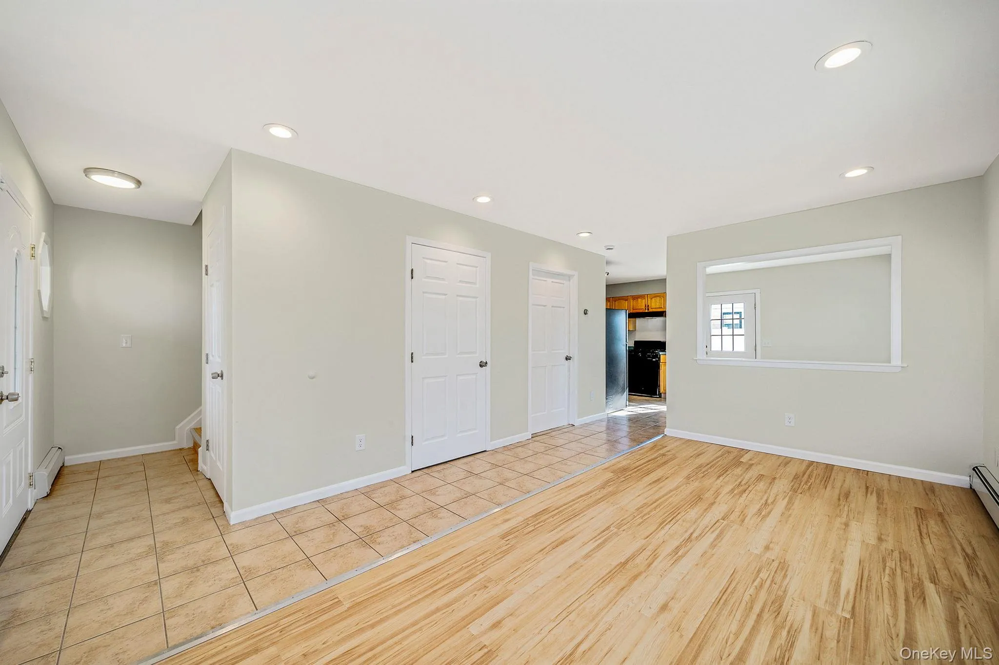 Unfurnished room with recessed lighting, light tile patterned floors, and baseboard heating Unfurnished room with recessed lighting, light tile patterned floors, and baseboard heating