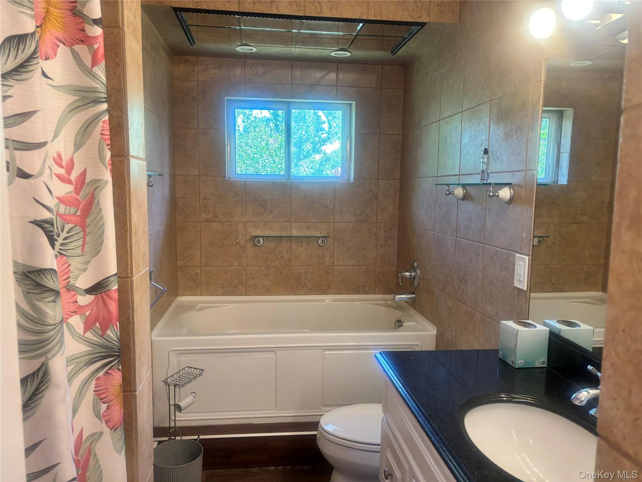 Bathroom with vanity, plenty of natural light, and a combined bath / shower with rainfall shower Bathroom with vanity, plenty of natural light, and a combined bath / shower with rainfall shower