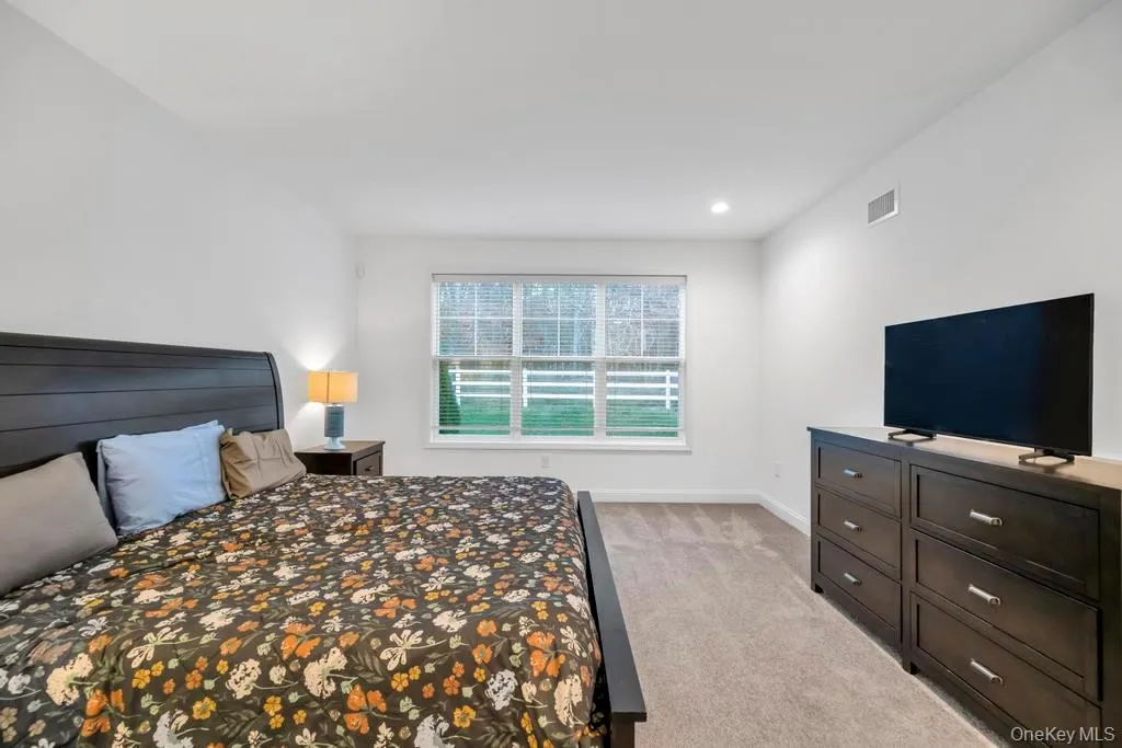 Bedroom featuring light colored carpet and recessed lighting Bedroom featuring light colored carpet and recessed lighting