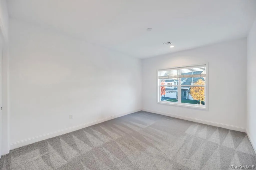 Empty room featuring light colored carpet and recessed lighting Empty room featuring light colored carpet and recessed lighting