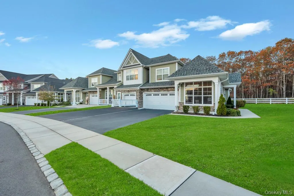 Craftsman-style home featuring driveway, stone siding, an attached garage, and a shingled roof Craftsman-style home featuring driveway, stone siding, an attached garage, and a shingled roof