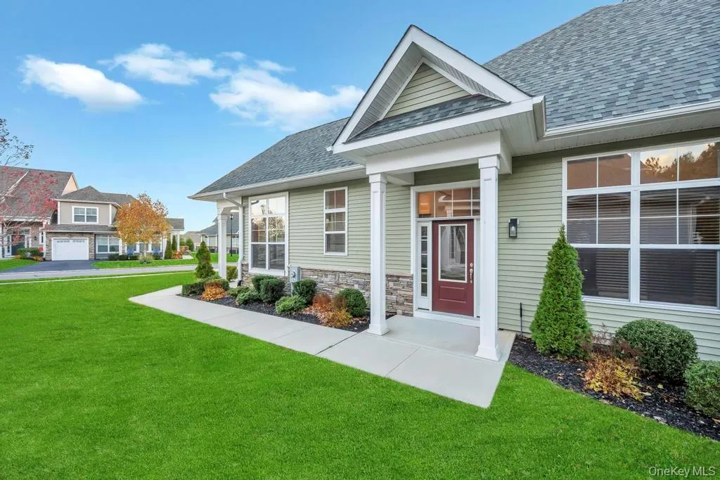 View of front of house featuring a front lawn, roof with shingles, and stone siding View of front of house featuring a front lawn, roof with shingles, and stone siding