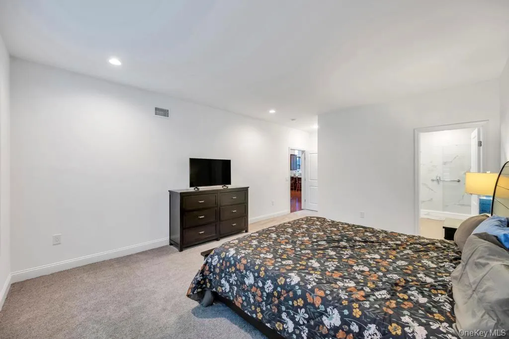 Bedroom with light colored carpet and recessed lighting Bedroom with light colored carpet and recessed lighting