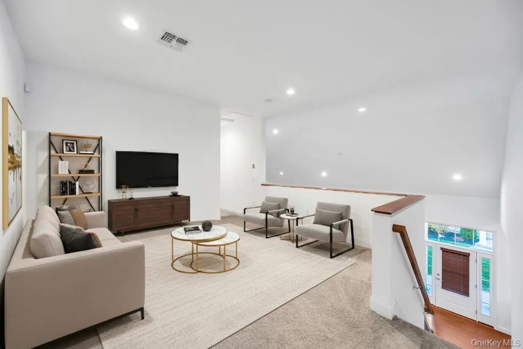 Living room featuring recessed lighting and light colored carpet Living room featuring recessed lighting and light colored carpet