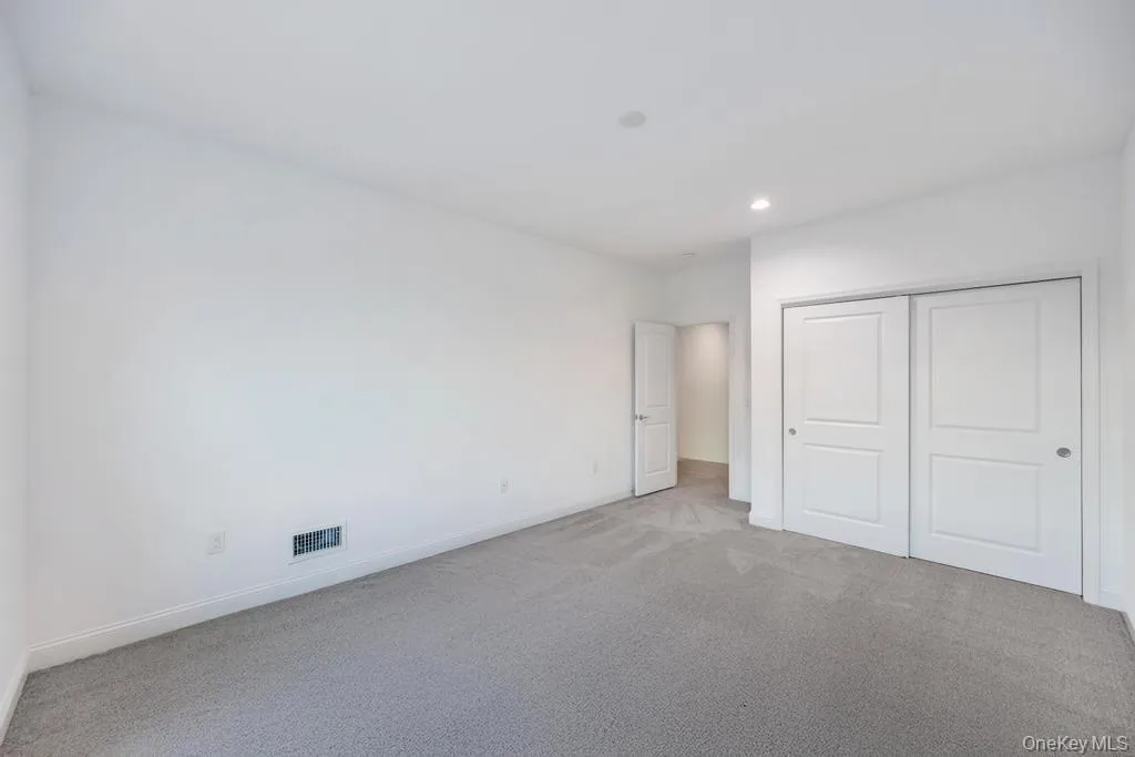Unfurnished bedroom featuring carpet flooring, a closet, and recessed lighting Unfurnished bedroom featuring carpet flooring, a closet, and recessed lighting